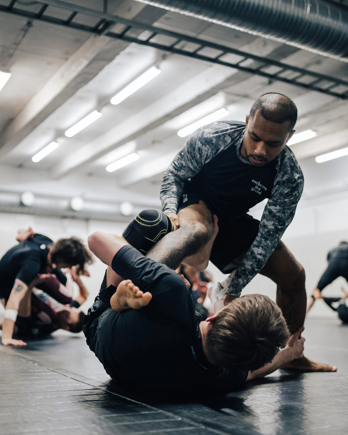 Athlete wearing camo long sleeve rashguard during MMA training